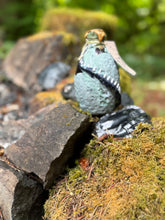 Load image into Gallery viewer, Gray-green mottled dragon egg potion bottle with bronze eruption shimmer activated, lightning bolt charm