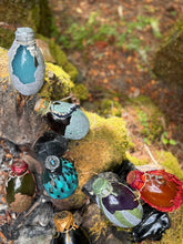 Load image into Gallery viewer, Dragon egg potion bottle collection at mossy stone firepit, wide view