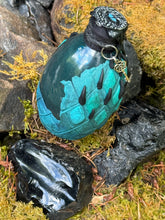 Load image into Gallery viewer, Teal gradient dragon egg potion bottle with teal shimmer liquid activated, front view