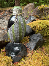 Load image into Gallery viewer, Mottled gray and moss-green dragon egg with stone-like mossy texture, silver highlights, triquetra charm