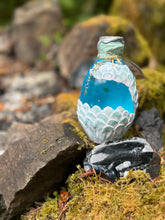 Load image into Gallery viewer, Back view of pearly white dragon egg showing rounded scale pattern with color-changing mica finish
