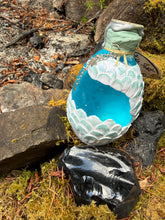 Load image into Gallery viewer, Teal gradient dragon egg showing activated teal shimmer through glass viewport, side angle
