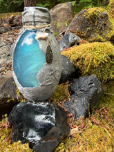 Load image into Gallery viewer, Light gray dragon egg potion bottle with explosive ice blue reflective shimmer activated
