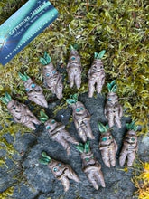 Load image into Gallery viewer, Rootling plant guardians from The Woodland Wandolier gathered on the mossy forest floor
